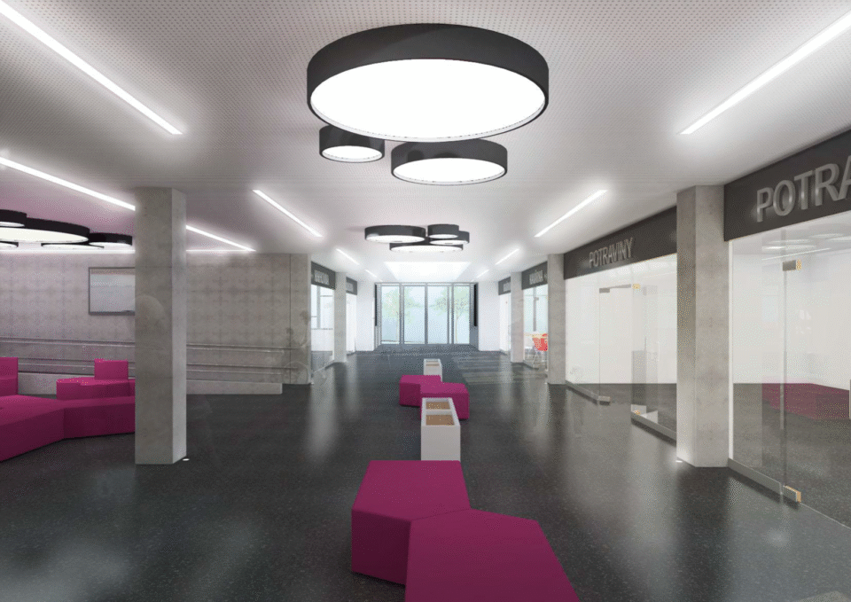 Moderní interiér s minimalistickým designem a elegantními světly, růžové pohovky a skleněné dveře vytvářejí otevřený a přívětivý prostor pro návštěvníky.